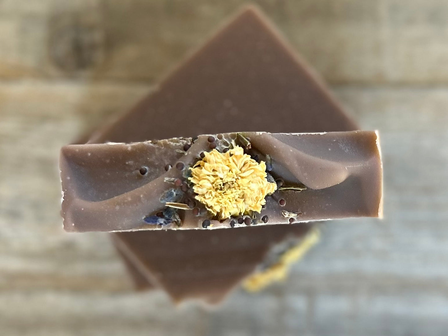 Take a step into the country with Wild Lavender soap. Scented with lavender, patchouli and juniper essential oil and sandalwood powder. It's the perfect blend of rich earthy floral.&nbsp; Made with nourishing goat's milk, olive oil, coconut oil, cocoa butter, avocado oil and castor oil. This soap is naturally colored with purple Brazilian clay and sandalwood powder for light exfoliation. Topped with lavender buds, broccoli seeds and a white chrysanthemum. Kendrick Homestead