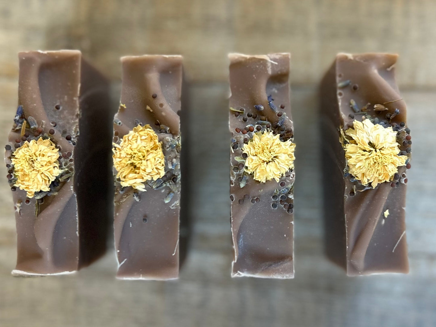 Take a step into the country with Wild Lavender soap. Scented with lavender, patchouli and juniper essential oil and sandalwood powder. It's the perfect blend of rich earthy floral.&nbsp; Made with nourishing goat's milk, olive oil, coconut oil, cocoa butter, avocado oil and castor oil. This soap is naturally colored with purple Brazilian clay and sandalwood powder for light exfoliation. Topped with lavender buds, broccoli seeds and a white chrysanthemum. Kendrick Homestead