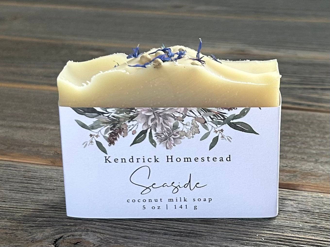 Seaside soap is made with coconut milk, olive oil, coconut oil, cocoa butter, avocado oil and castor oil with a relaxing smell of eucalyptus and spearmint essential oils. It is sprinkled with blue corn flowers and white peppercorns. Naturally colored with white kaolin clay and indigo powder. Kendrick Homestead.