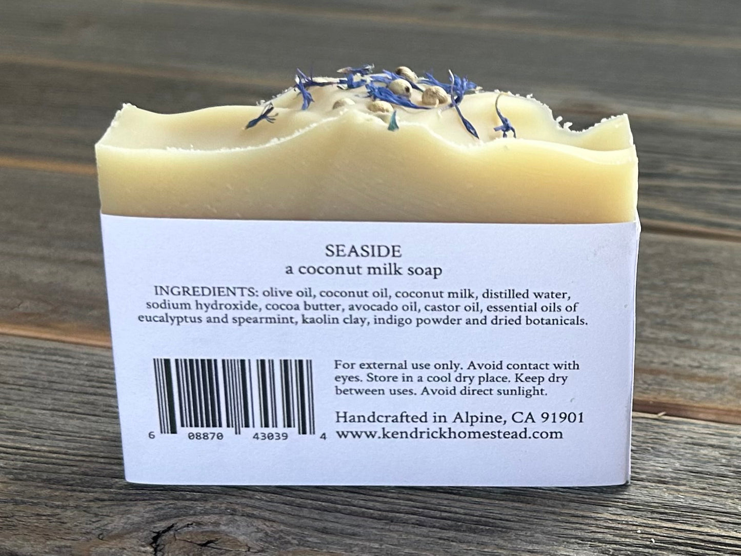 Seaside soap is made with coconut milk, olive oil, coconut oil, cocoa butter, avocado oil and castor oil with a relaxing smell of eucalyptus and spearmint essential oils. It is sprinkled with blue corn flowers and white peppercorns. Naturally colored with white kaolin clay and indigo powder. Kendrick Homestead.