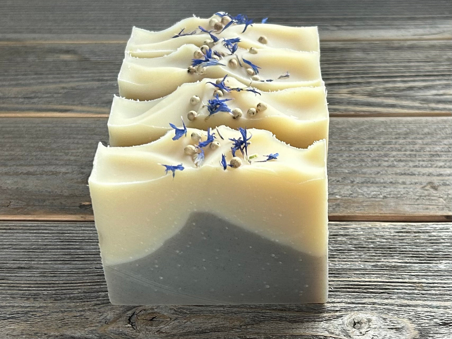 Seaside soap is made with coconut milk, olive oil, coconut oil, cocoa butter, avocado oil and castor oil with a relaxing smell of eucalyptus and spearmint essential oils. It is sprinkled with blue corn flowers and white peppercorns. Naturally colored with white kaolin clay and indigo powder. Kendrick Homestead.