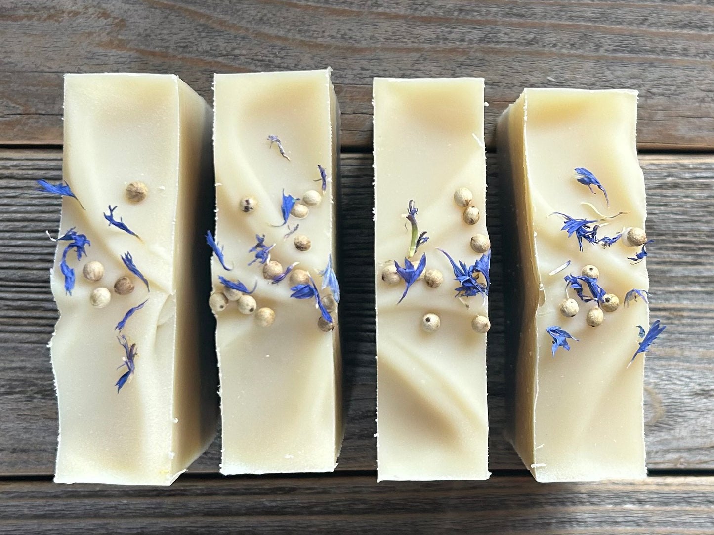 Seaside soap is made with coconut milk, olive oil, coconut oil, cocoa butter, avocado oil and castor oil with a relaxing smell of eucalyptus and spearmint essential oils. It is sprinkled with blue corn flowers and white peppercorns. Naturally colored with white kaolin clay and indigo powder. Kendrick Homestead.