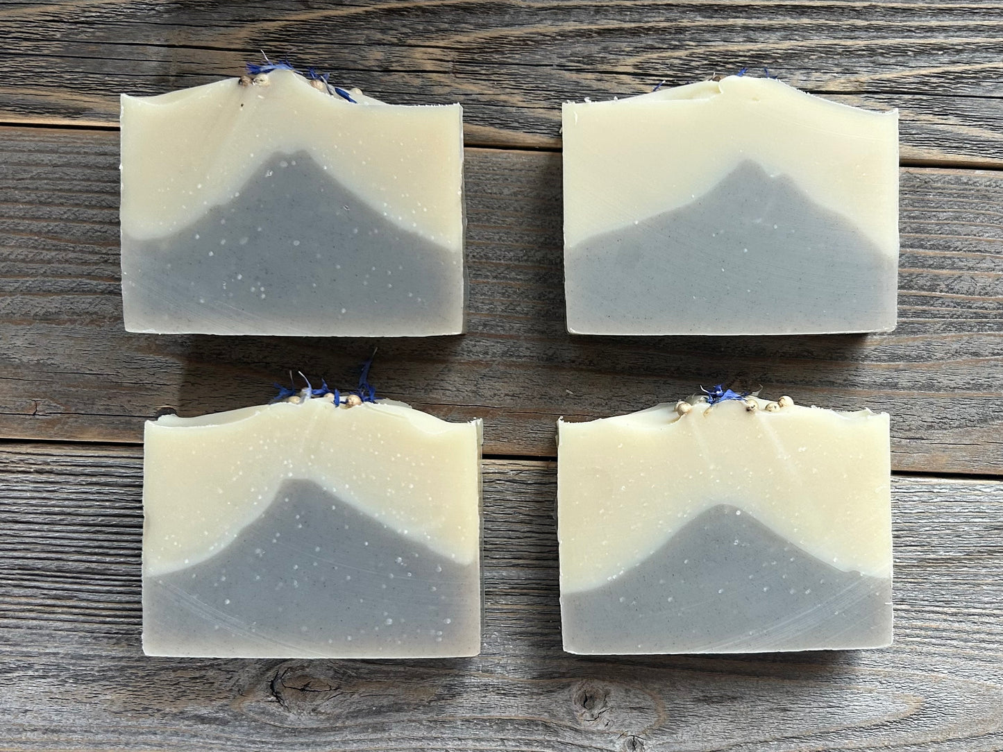 Seaside soap is made with coconut milk, olive oil, coconut oil, cocoa butter, avocado oil and castor oil with a relaxing smell of eucalyptus and spearmint essential oils. It is sprinkled with blue corn flowers and white peppercorns. Naturally colored with white kaolin clay and indigo powder. Kendrick Homestead.