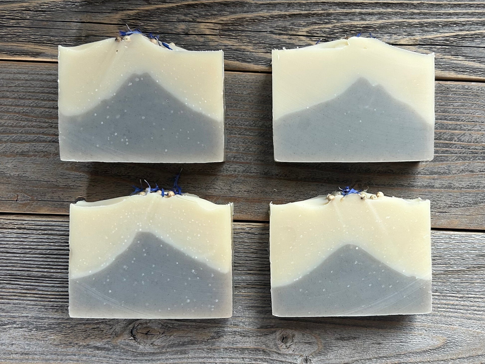 Seaside soap is made with coconut milk, olive oil, coconut oil, cocoa butter, avocado oil and castor oil with a relaxing smell of eucalyptus and spearmint essential oils. It is sprinkled with blue corn flowers and white peppercorns. Naturally colored with white kaolin clay and indigo powder. Kendrick Homestead.