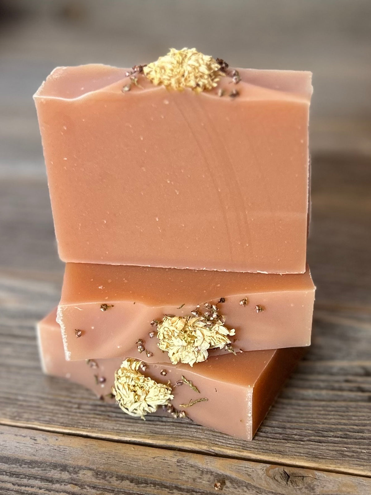 Citrus Blossom Soap is a delicious citrus blend of grapefruit, lemongrass and lime. Made with soothing goat's milk, cocoa butter, creamy shea butter and avocado oil. Naturally colored with rose clay and topped with a variety of dried flowers. Kendrick Homestead
