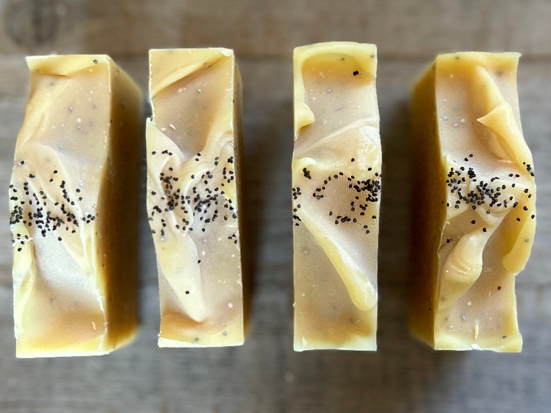 Lemon Poppy Seed soap is made with nourishing goat's milk, olive oil, coconut oil, cocoa butter, shea butter and castor oil. It has the vibrant smell of lemon, pink grapefruit and litsea cubeba essential oil. Kaolin clay and poppy seeds are added for light exfoliation. Kendrick Homestead