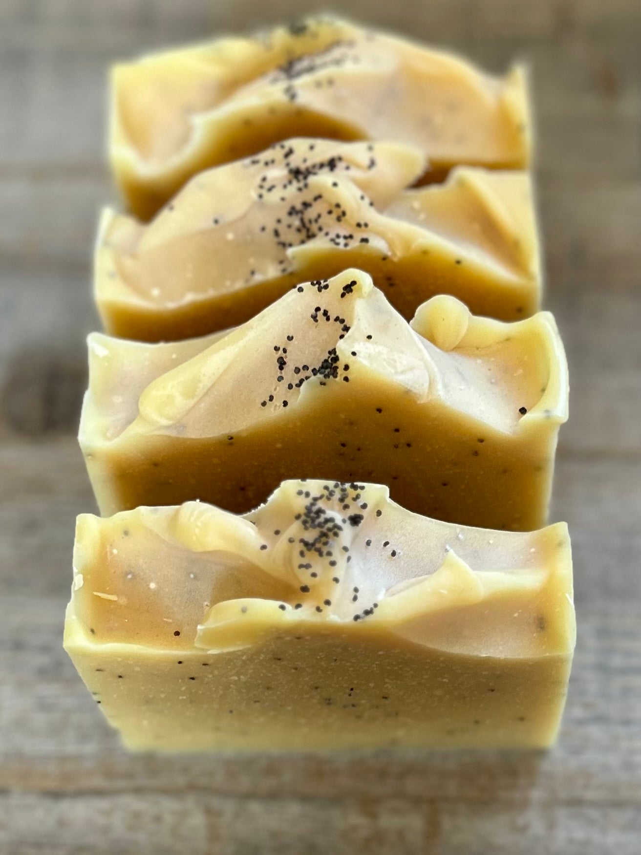 Lemon Poppy Seed soap is made with nourishing goat's milk, olive oil, coconut oil, cocoa butter, shea butter and castor oil. It has the vibrant smell of lemon, pink grapefruit and litsea cubeba essential oil. Kaolin clay and poppy seeds are added for light exfoliation. Kendrick Homestead