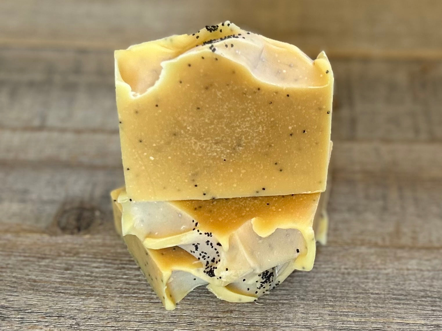 Lemon Poppy Seed soap is made with nourishing goat's milk, olive oil, coconut oil, cocoa butter, shea butter and castor oil. It has the vibrant smell of lemon, pink grapefruit and litsea cubeba essential oil. Kaolin clay and poppy seeds are added for light exfoliation. Kendrick Homestead