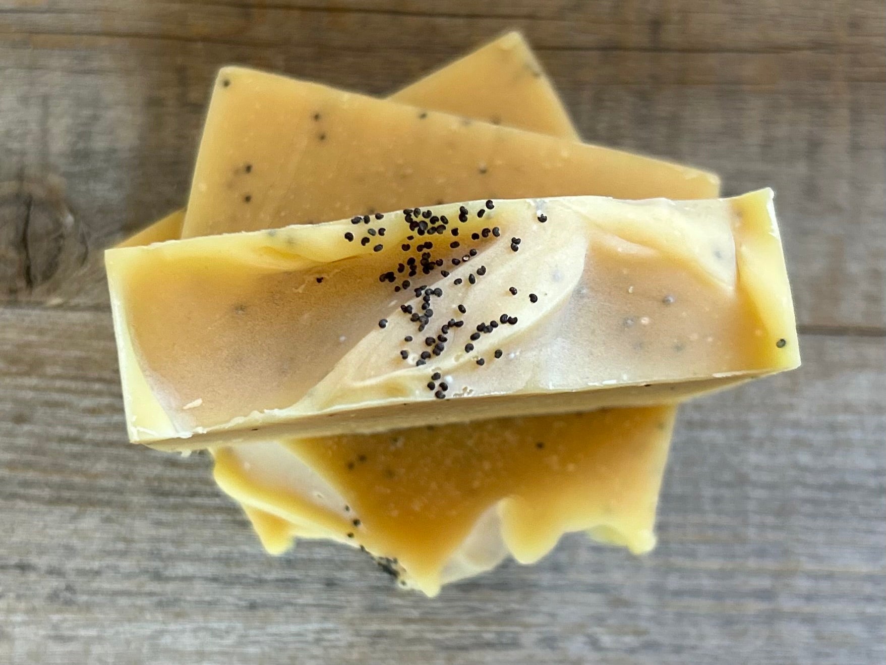 Lemon Poppy Seed soap is made with nourishing goat's milk, olive oil, coconut oil, cocoa butter, shea butter and castor oil. It has the vibrant smell of lemon, pink grapefruit and litsea cubeba essential oil. Kaolin clay and poppy seeds are added for light exfoliation. Kendrick Homestead