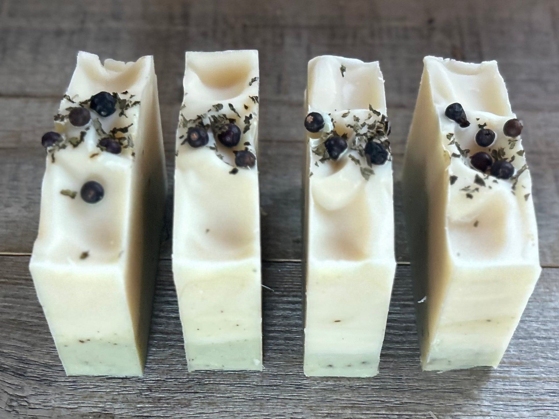 Into The Woods soap is made with a blend of peppermint, spearmint and rosemary essential oil for a refreshing, cooling effect on the skin. This blend will ease your mind and clear your senses. Made with nourishing goat's milk, cocoa butter, avocado oil, kaolin clay, french green clay and ground juniper berries for light exfoliation. Kendrick Homestead