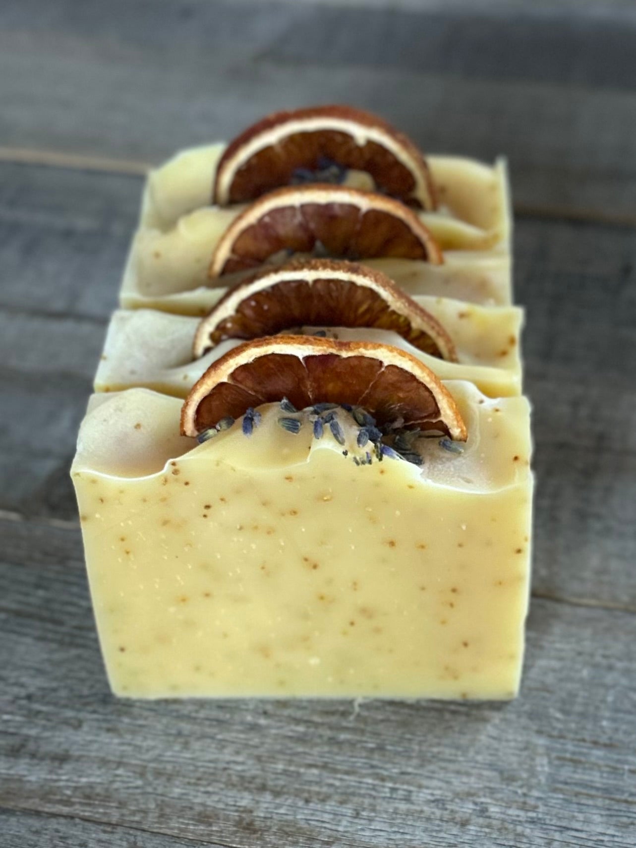 Jump start your morning routine with the invigorating smell of Orange Lavender soap. Made with nourishing goat's milk, cocoa butter, shea butter, avocado oil, kaolin clay and orange peel to lightly exfoliate, refresh and soften the skin.  Kendrick Homestead